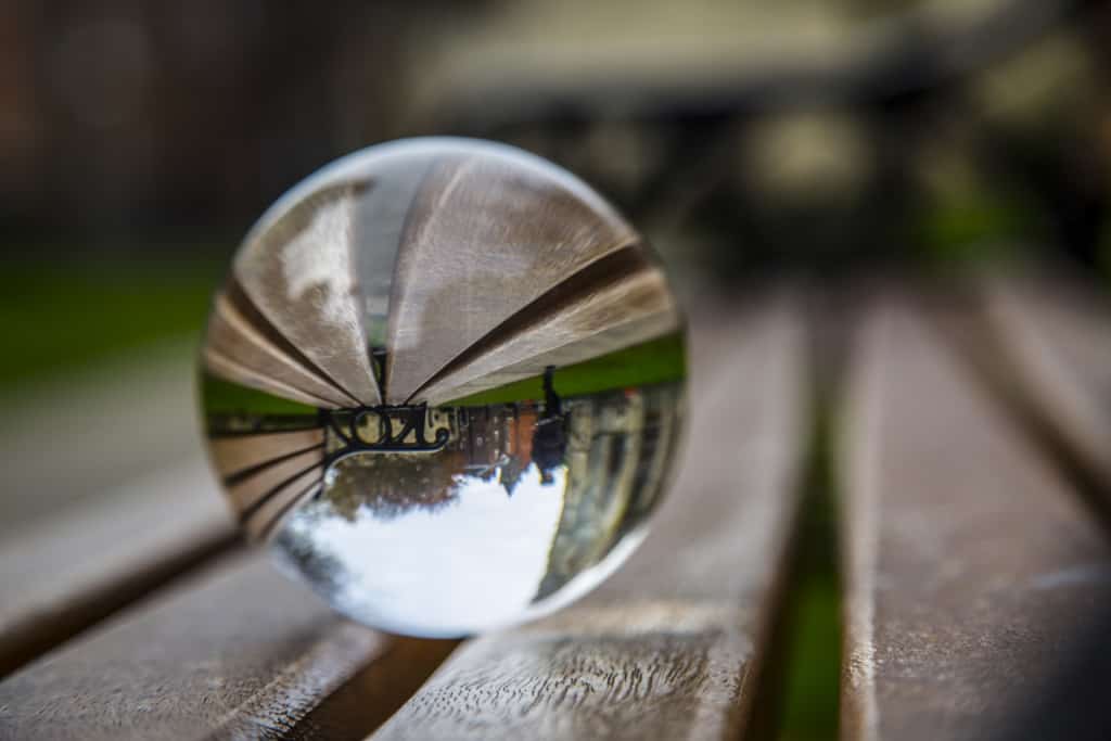 Transparent marble ball shows the reality as we know it reverse upside down