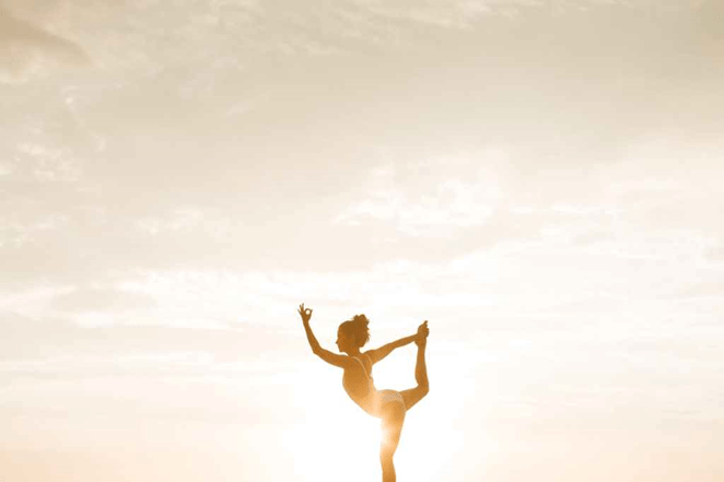 A free woman dancing freely in sunrise living who she really is doing what she wants
