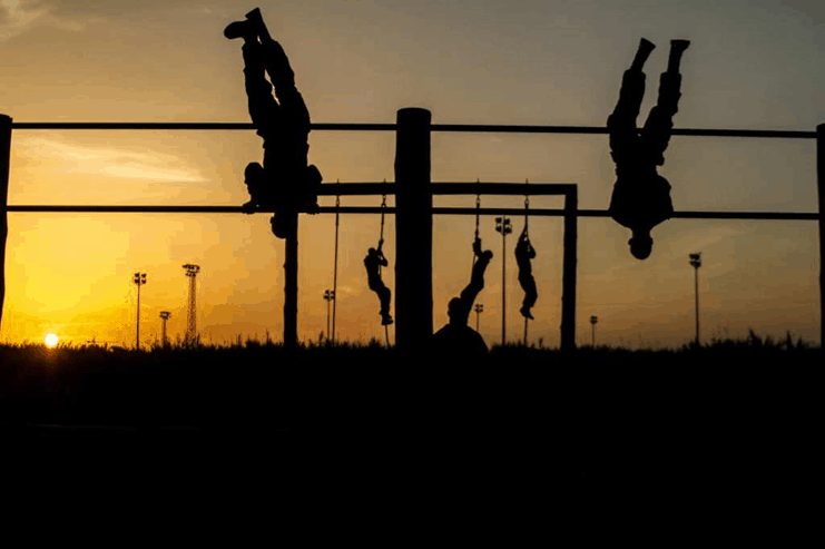 Soldiers training in an obstacle course  during sunset
