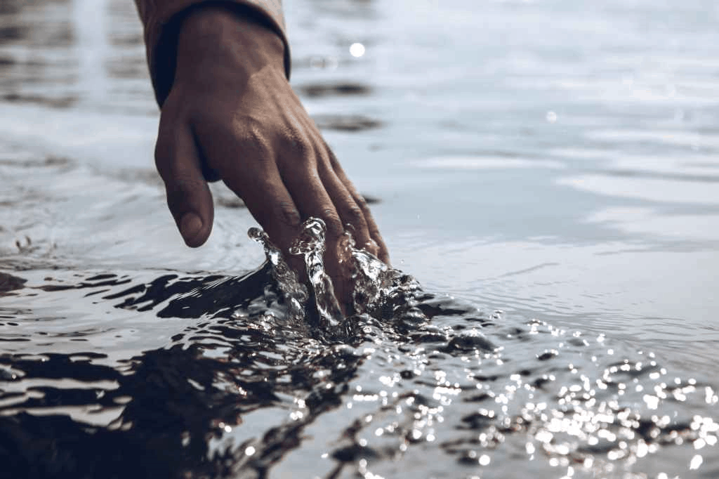 A hand touching water surface with neuro linguistic programming
