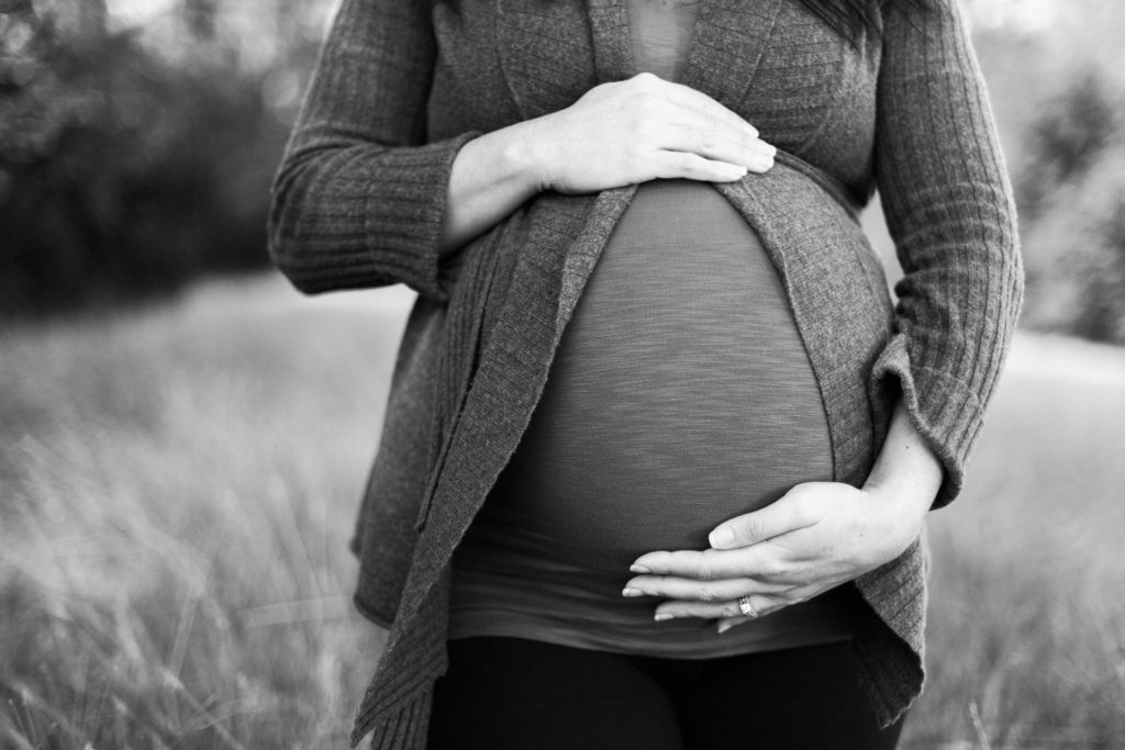 Pregnant woman struggling with the idea of aborting her baby