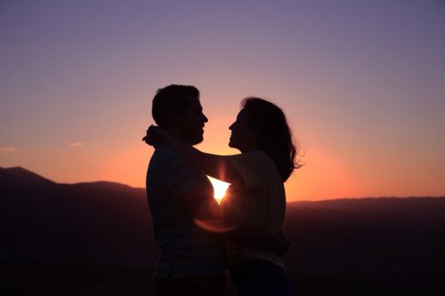 Beautiful couple sharing love with each in the sunset