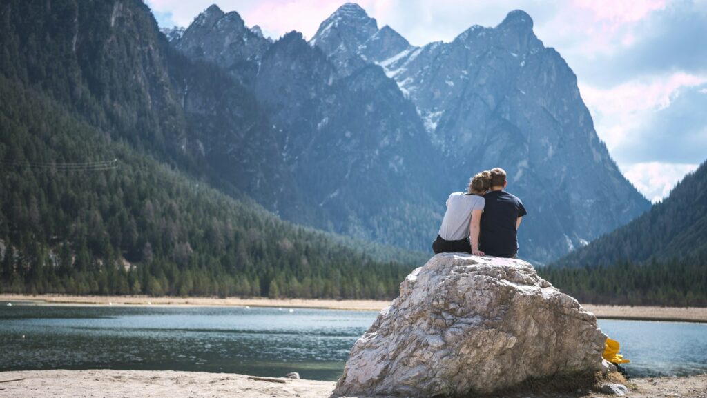 A beautiful couple sitting together in a beautiful lake with a great Edgar Allan Poe quote - 50 Best Love of My Life Quotes